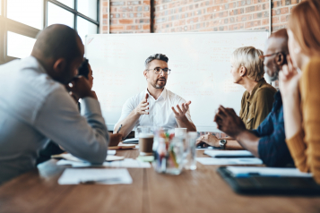 Shot of a businessman leading a meeting in the boardroom