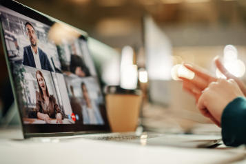 Laptop showing a group video call during an AI readiness assessment interview with several leaders on screen.